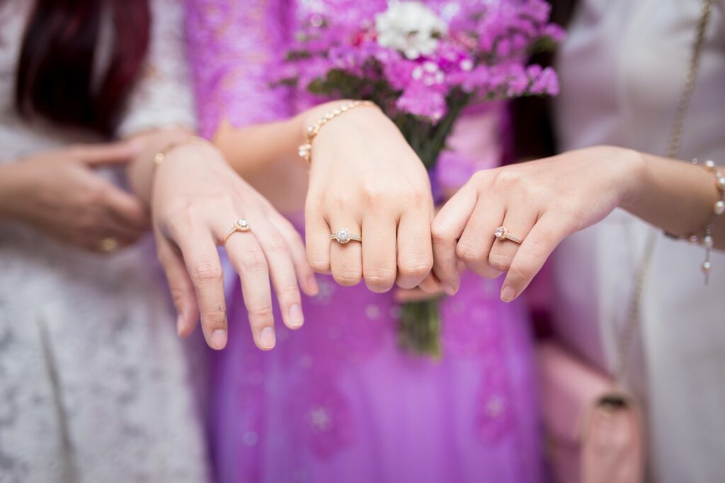 women showing off sterling silver engagement rings