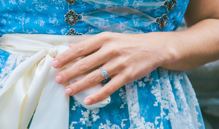 photo of woman's hand on her waist wearing blue dress and a Moissanite ring
