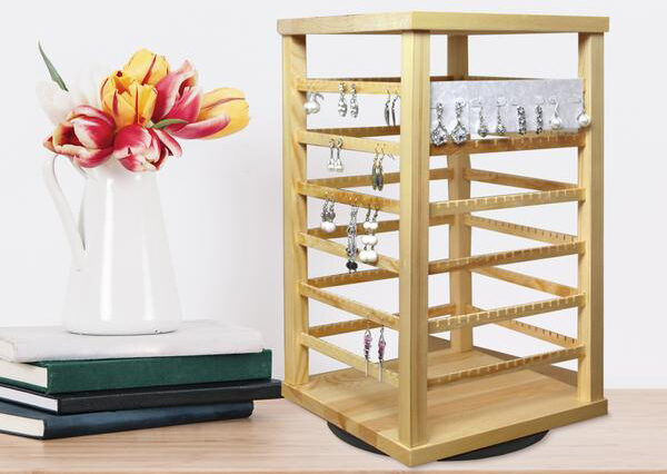 natural wood rotating earring display from Nile Corp on a wooden table