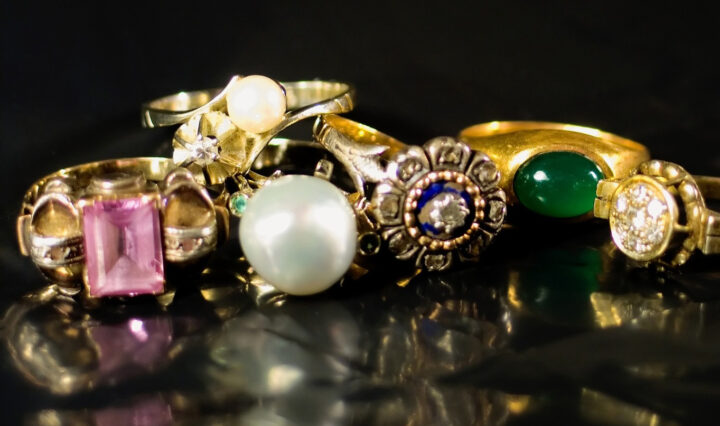 gold fashion rings with crystals on a black surface