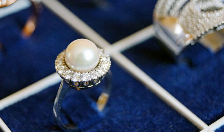 pearl silver ring displayed in a blue ring tray