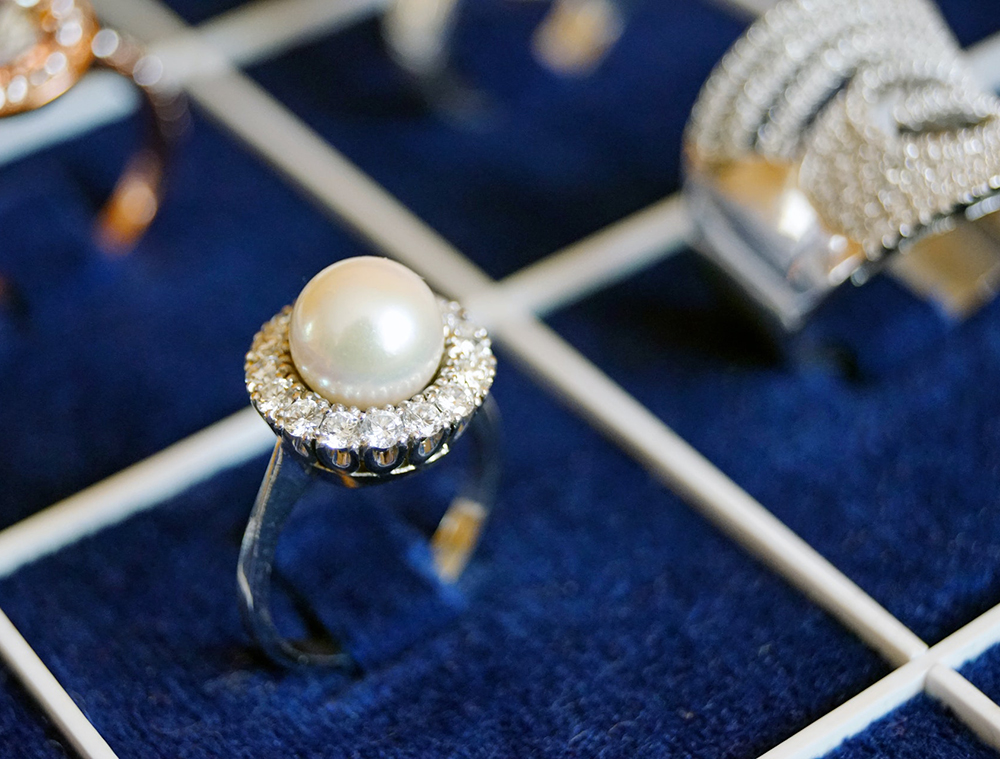 pearl silver ring displayed in a blue ring tray